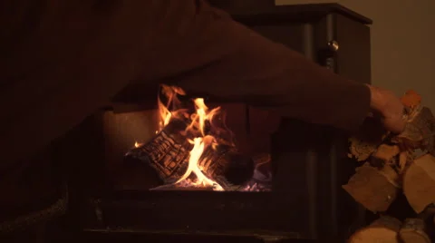 Putting logs in fireplace. Slow Motion. Stock Footage 51805800