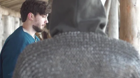 Putting mail armor on, Vikings in slow-mo flat image Stockbeeldmateriaal 89121575