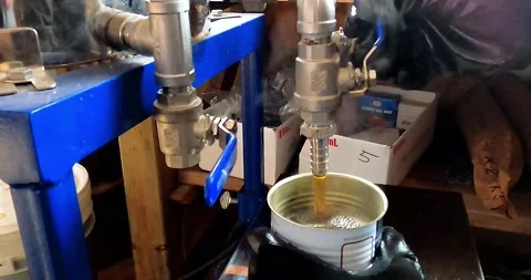 Putting maple syrup in cans in maple syrup production Video stock 167173184