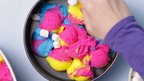 Putting Marshmallows On Rainbow Ice Cream Stock Footage 87771257