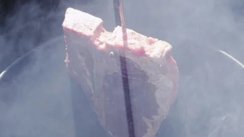 Putting meat in a barrel for grilling Stock Footage 154214532