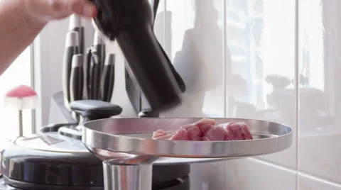 Putting meat in a meat grinder Video stock 55560507