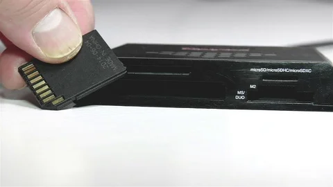 Putting a memory card to an adapter and to a card reader, 4K 스톡 동영상 84163506