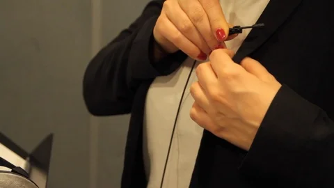 Putting microphone on Stock Footage 125033532