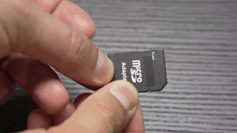 Putting MicroSD Card in SD Card adapter. Close Up Video stock 161606150