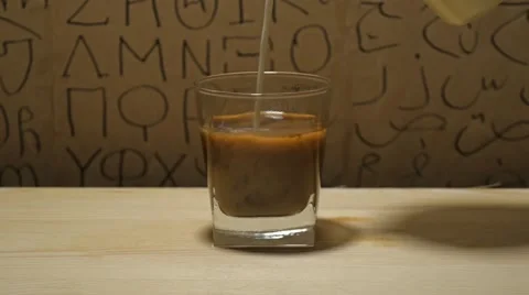 Putting milk in coffee Stock Footage 60799451