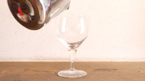 Putting milk first and then coffee using spoon in clear glass cup Stock Footage 106909724