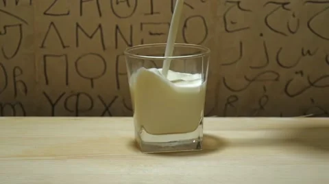 Putting milk into a glass Stock Footage 60799458