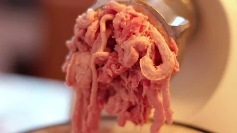 Putting minced meat and vegetable mixture through mincer at home at home Stock Footage