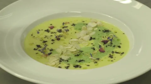 Putting mint on a soup ready to be served Stock Footage 71549539
