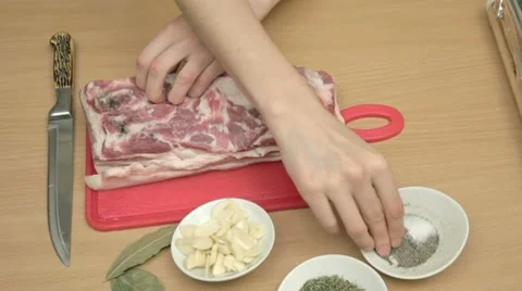 Putting mixed pepper with salt in pre-punctured bacon Stock Footage 7740899