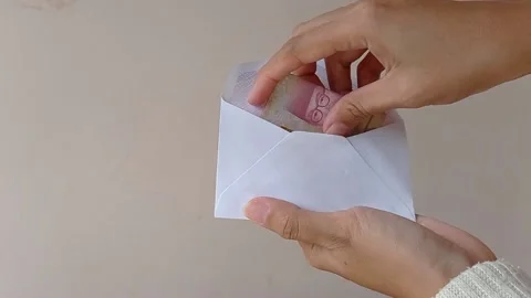 Putting in money into a small envelope Stock Footage 151021138