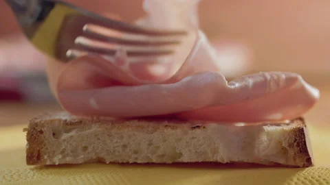 Putting mortadella on rustic bread Stock Footage 231012585