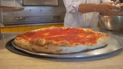 Putting mozzarella cheese over pizza with tomato sauce Stock Footage 71546668
