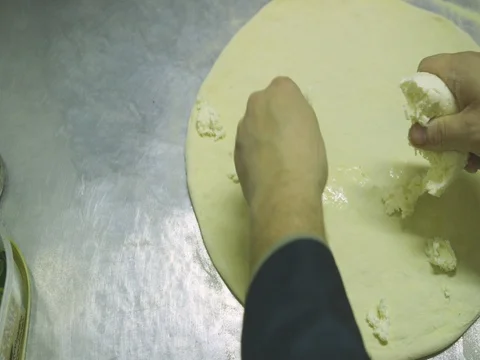 Putting mozzarella cheese on pizza dough 6 Stock Footage 80673921