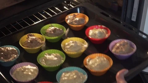 Putting muffins into the oven Stock Footage 85141157