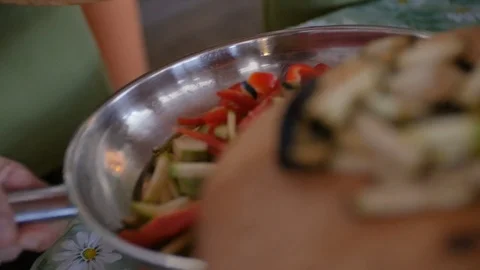 Putting multiple raw vegetables into the pan to cook fetuchini Stock Footage 75393614