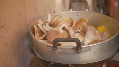 Putting mushroom into the pot Stock Footage 86204587