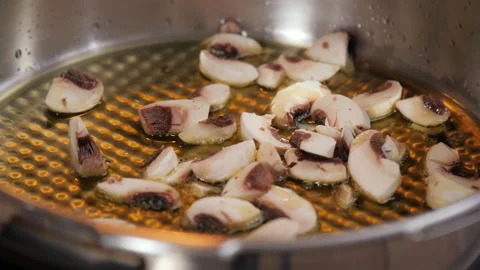 Putting mushrooms in the pan Stock Footage 154338424