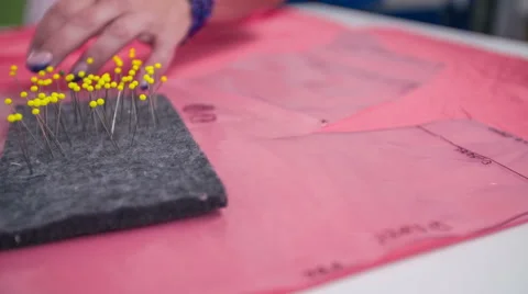Putting needle in to plastic paper with textile under in close up Stock Footage 41013067