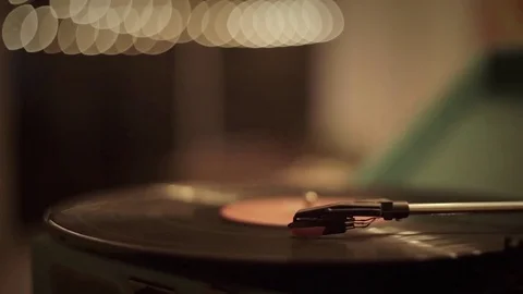 Putting needle on a turning vinyl disc Stock Footage
