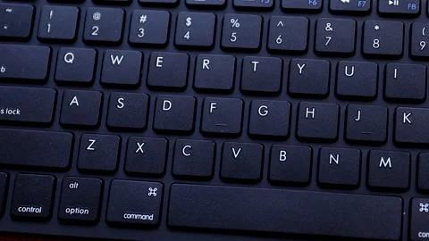 Putting note with password on keyboard and writing it down Stock Footage 138550851