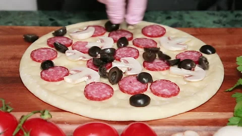 Putting olives on pizza Stock Footage 141798445