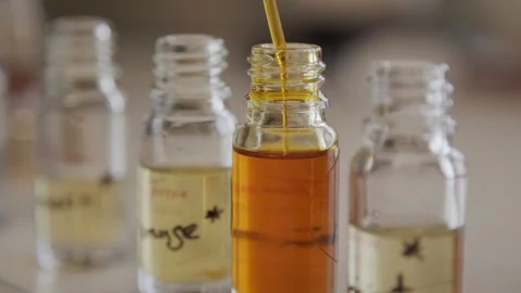 Putting Orange Liquid into Small Bottle with Pipette Video stock 111757199