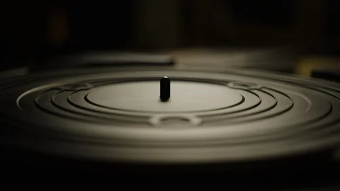 Putting an orange vinyl record on turntable and putting stylus needle on Video stock 129572632