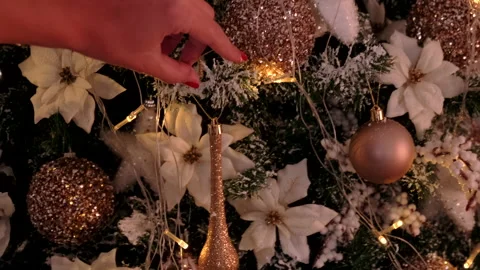 Putting ornaments on a christmas tree. Stock Footage 221858787