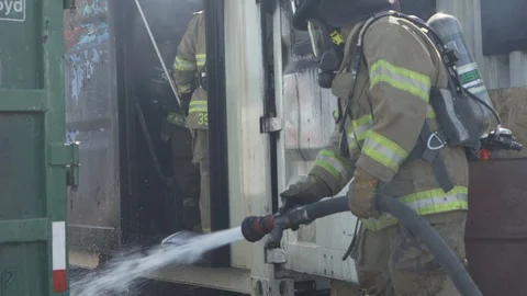 Putting out a barrel fire Stock Footage 130081133