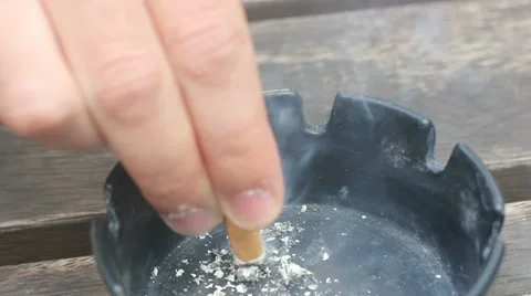 Putting out cigarette in ash tray Stock Footage 10897584