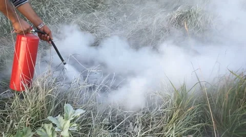 Putting out the fire with a fire extinguisher Stock Footage 68647836