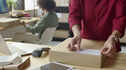 Putting Paper Label on Parcel for Delivery 動画素材 228490672