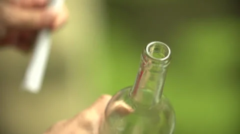 Putting a paper message in a bottle in slow motion (200fps) Stock-Footage 23482253