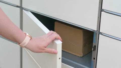 Putting a parcel to a parcel locker in 4k slow motion 60fps Stock Footage 155901375
