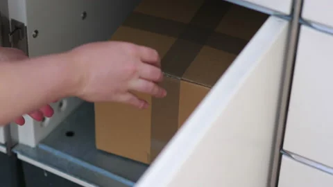 Putting a parcel to a parcel locker in 4k slow motion 60fps Stock Footage 155901481