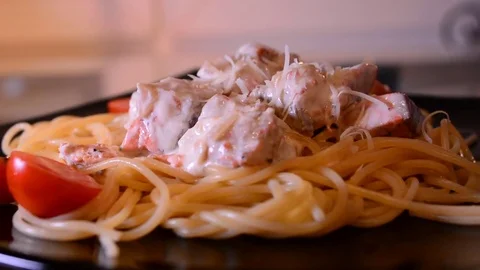 Putting parmesan cheese on spaghetti Stock Footage 82505946
