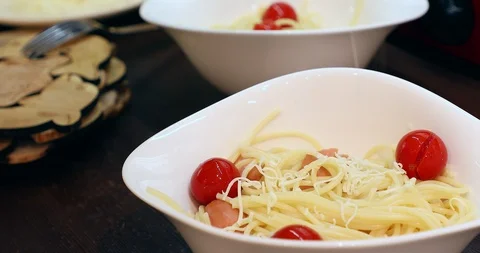 Putting parmesan cheese on spaghetti with tomato Stock Footage 88067967