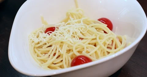 Putting parmesan cheese on spaghetti with tomato Stock Footage 88067985