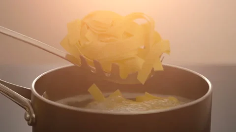 Putting pasta in to the pan with hot water Stock Footage 67993671
