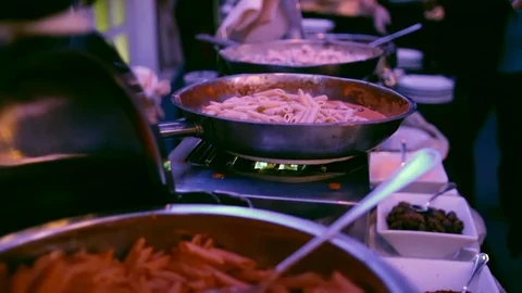 Putting pasta on plate from serving dish 動画素材 100723453