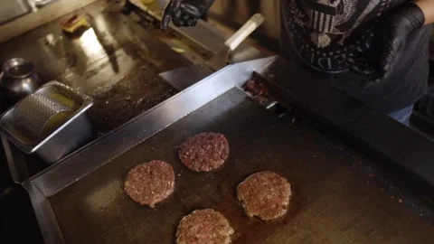 Putting Pattys On The Griddle Stock Footage 197056532
