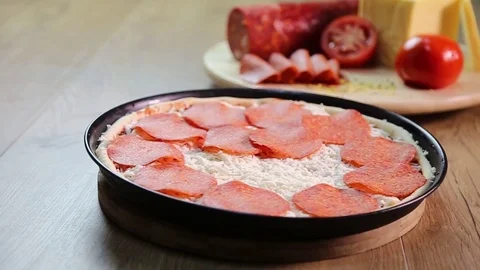 Putting peperoni on pizza Stock Footage 83546055