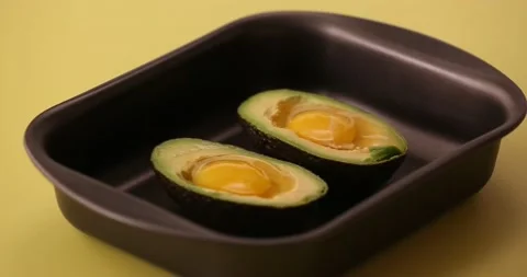 Putting pepper on the eggs and avocado 2 Stock Footage 132149584