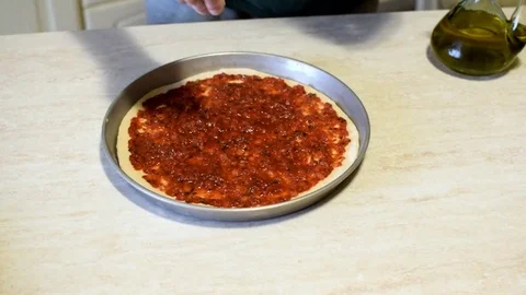 Putting pepperoni on pizza Stock Footage 76998029