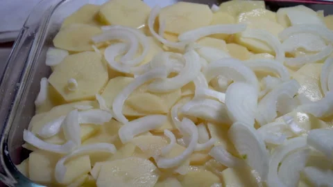 Putting the pices of onion into baking try Stock Footage 85928528