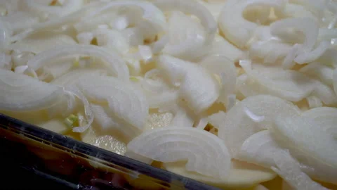 Putting the pices of onion into baking try Stock Footage 85969919