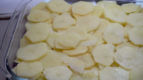 Putting the pices of potato into baking try Stock Footage 85921046
