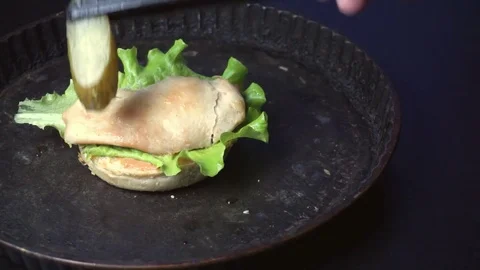 Putting pickles on bun Stock Footage 72960225